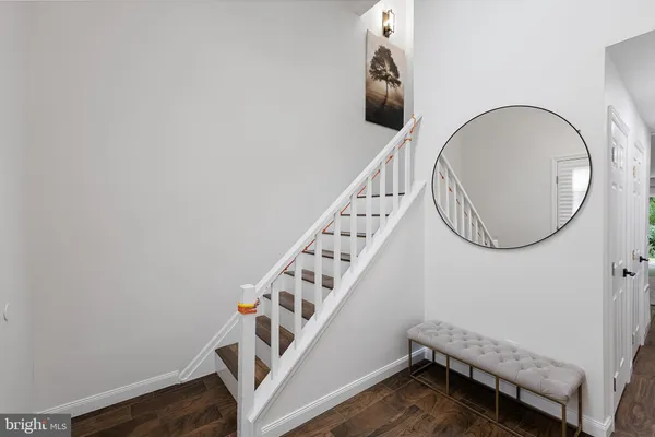 a view of a livingroom with wooden floor and stairs