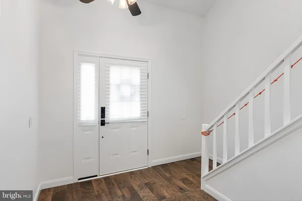 a view of an entryway with wooden floor