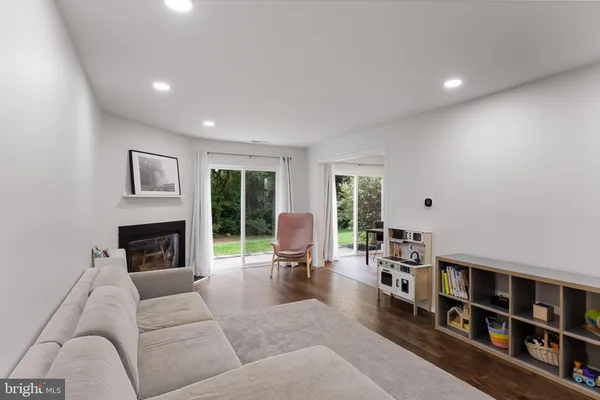 a living room with furniture fireplace and book shelf