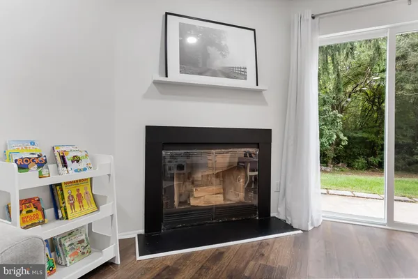 a living room with a fireplace and a floor to ceiling window