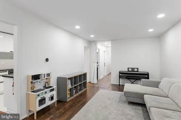 a view of living room with furniture and wooden floor
