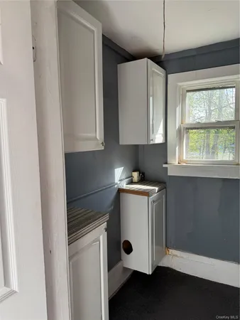 a kitchen with a refrigerator and a stove top oven