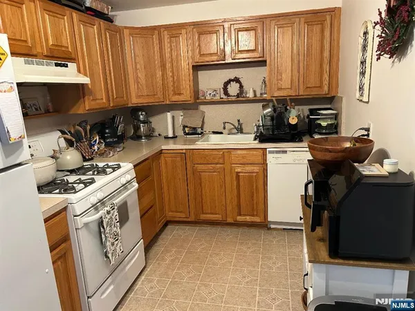 a kitchen with a stove a sink and a microwave