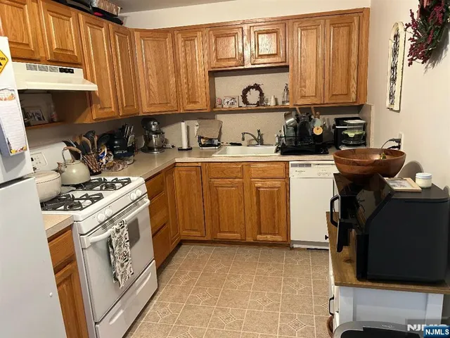 a kitchen with a stove a sink and a microwave