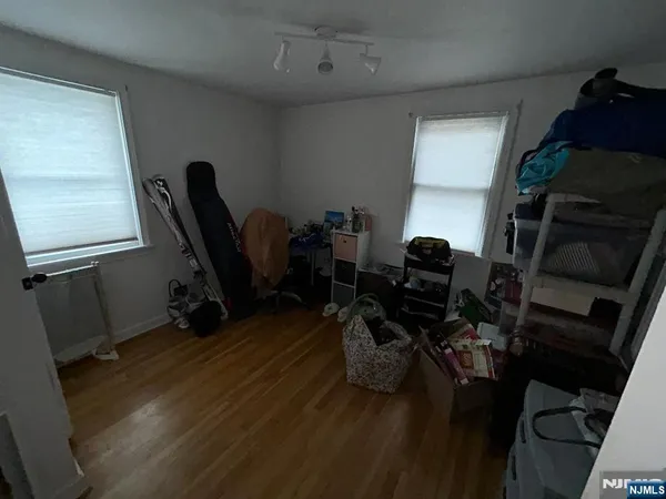 a view of workspace with wooden floor windows