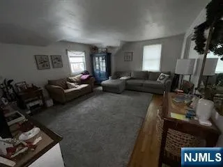 a living room with furniture window and a flat screen tv