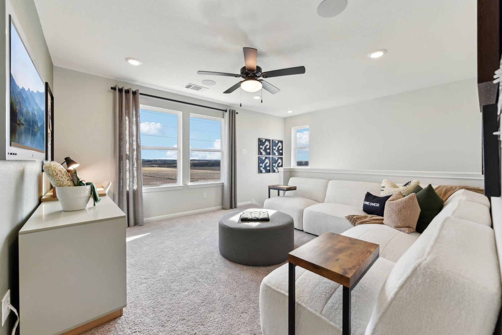 253 Firefox Way Jarrell, TX 76537 - Photo 12 of 17 Natural light floods this inviting living space, offering tranquil views of the expansive landscape.