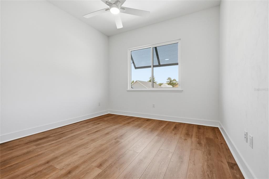 1063 Southwest 135th Way Newberry, FL 32669 - Photo 30 of 42 wooden floor in an empty room with a window