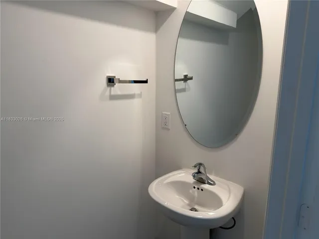a bathroom with a sink and mirror