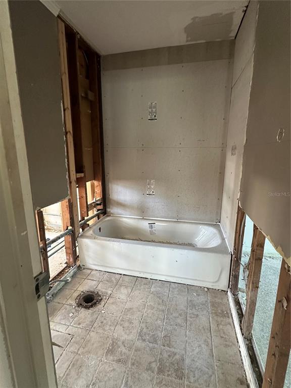 13434 1st Street East Madeira Beach, FL 33708 - Photo 12 of 15 a bathroom with a tub a sink and a shower