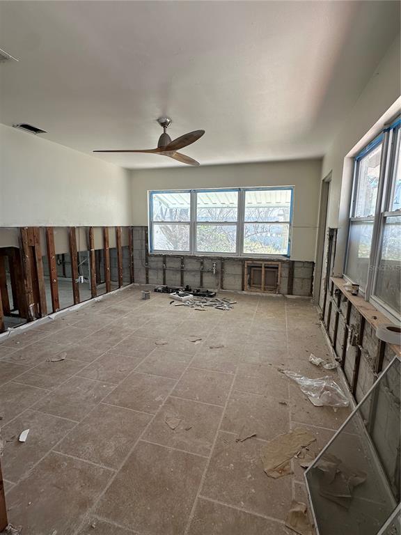 13434 1st Street East Madeira Beach, FL 33708 - Photo 14 of 15 a view of an empty room with wooden floor and windows