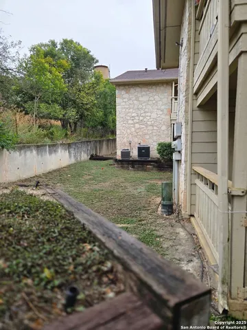 a view of a backyard with large trees