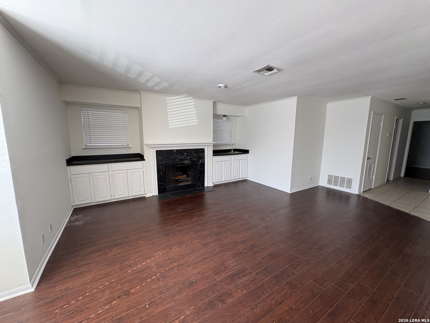 7738 Chambers Road, Unit 1101 San Antonio, TX 78229 - Photo 16 of 35 an empty room with wooden floor and fireplace
