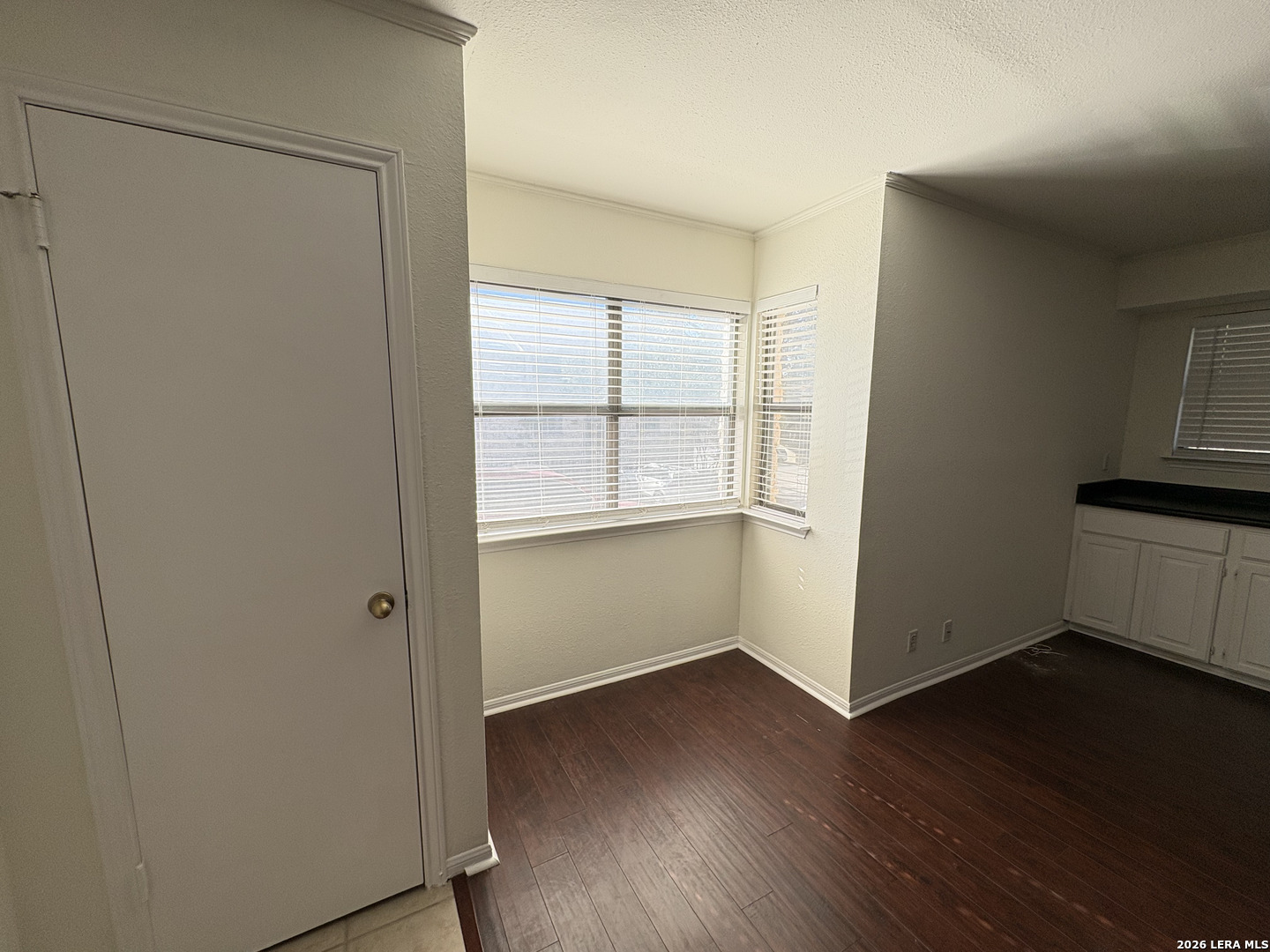 7738 Chambers Road, Unit 1101 San Antonio, TX 78229 - Photo 17 of 35 a view of an empty room with wooden floor and a window
