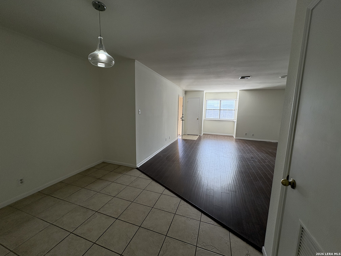 7738 Chambers Road, Unit 1101 San Antonio, TX 78229 - Photo 22 of 35 an empty room with wooden floor and window