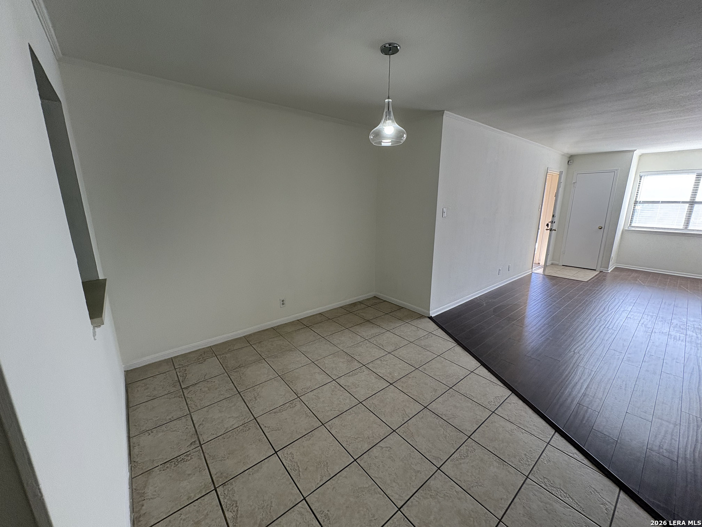 7738 Chambers Road, Unit 1101 San Antonio, TX 78229 - Photo 23 of 35 an empty room with wooden floor and windows