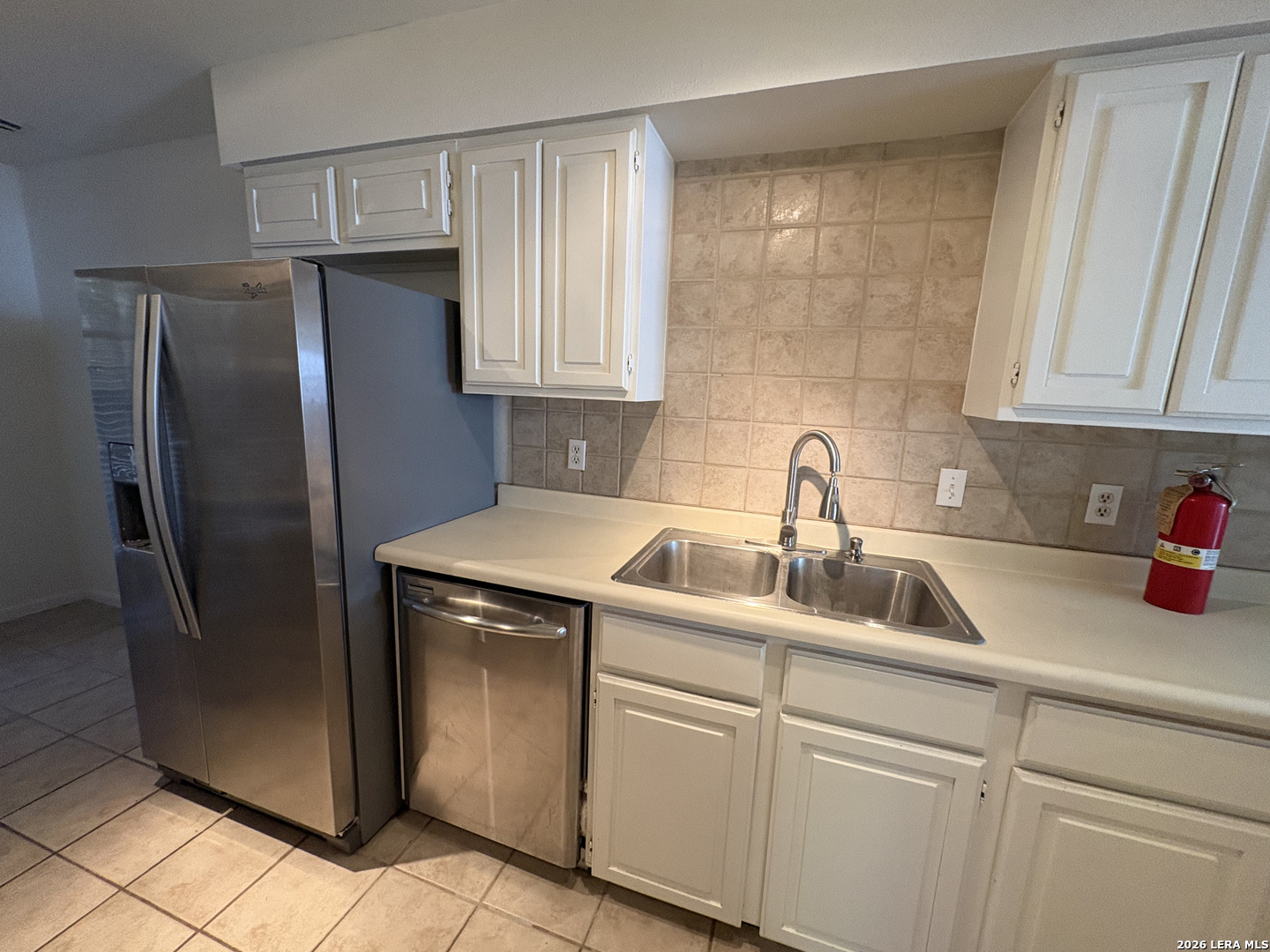 7738 Chambers Road, Unit 1101 San Antonio, TX 78229 - Photo 29 of 35 a kitchen with a refrigerator sink and cabinets