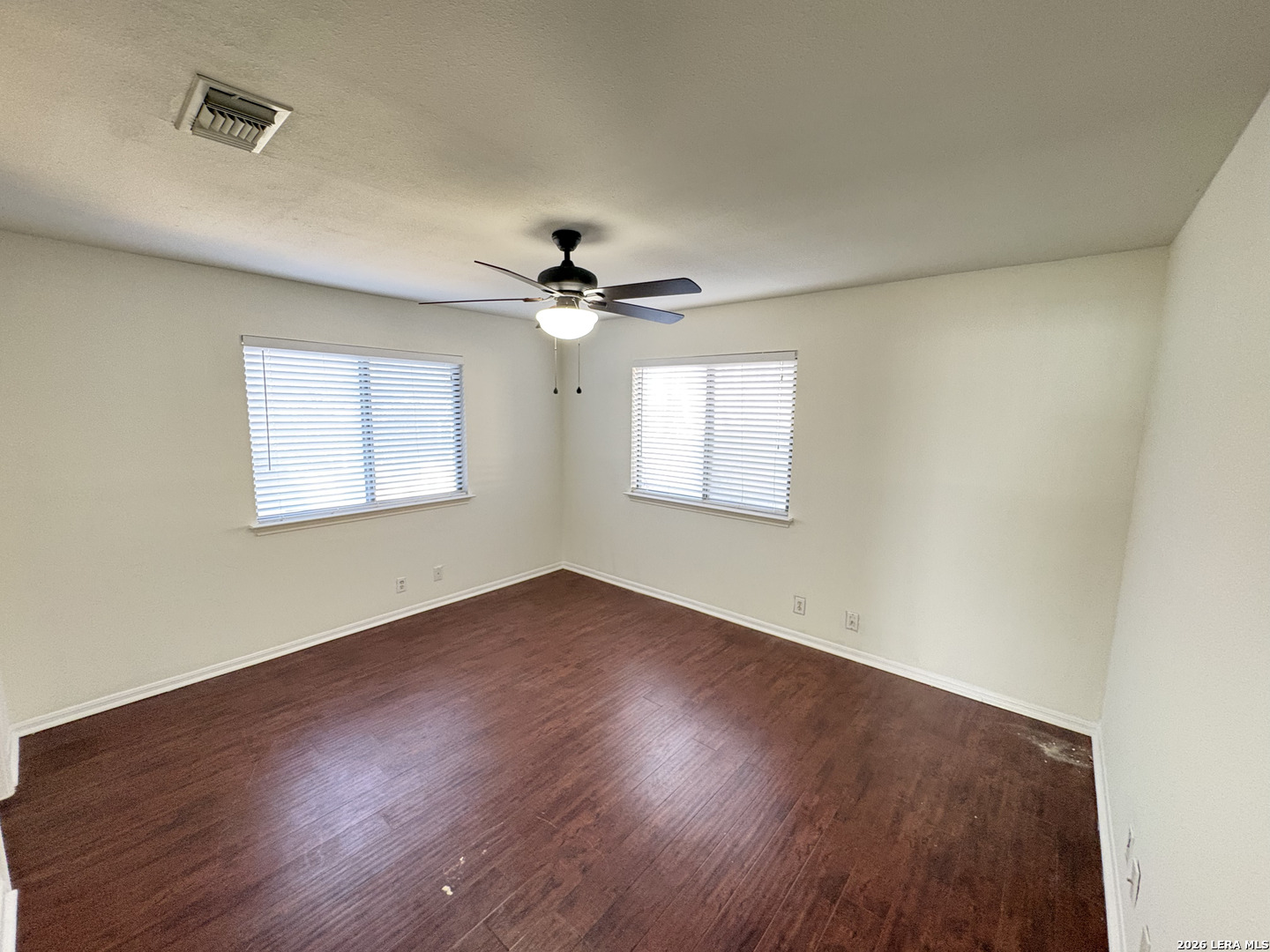 7738 Chambers Road, Unit 1101 San Antonio, TX 78229 - Photo 30 of 35 a view of an empty room with wooden floor and a window