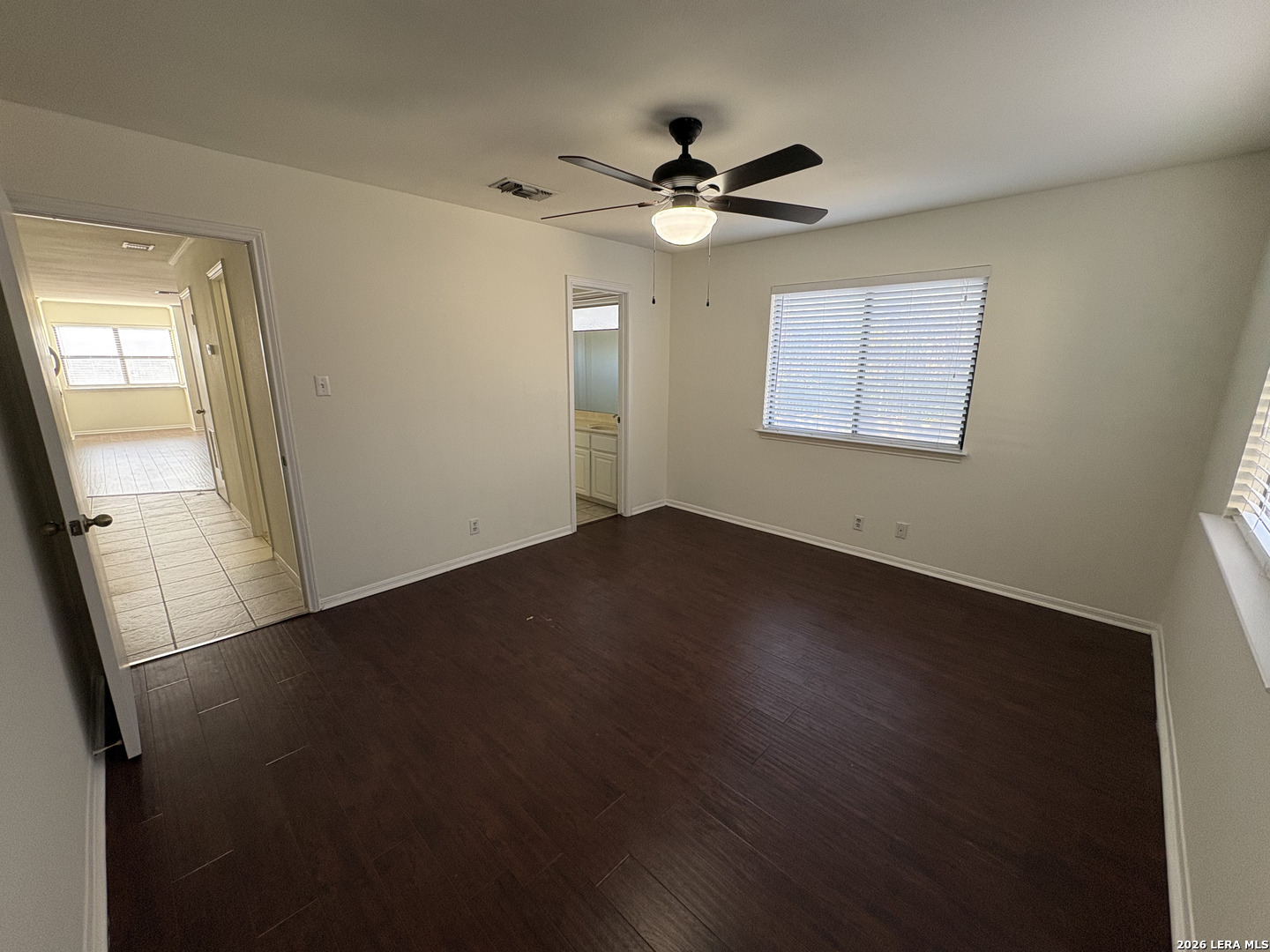 7738 Chambers Road, Unit 1101 San Antonio, TX 78229 - Photo 31 of 35 a view of an empty room with wooden floor and a window