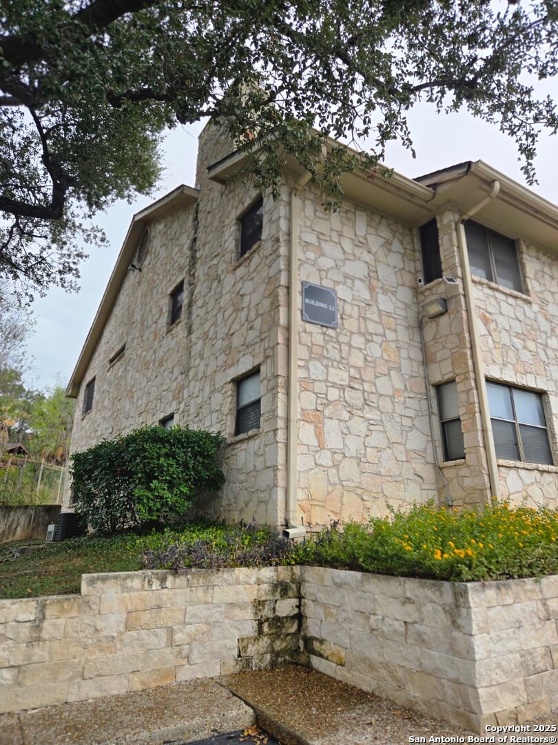 7738 Chambers Road, Unit 1101 San Antonio, TX 78229 - Photo 4 of 35 a front view of a house with a yard