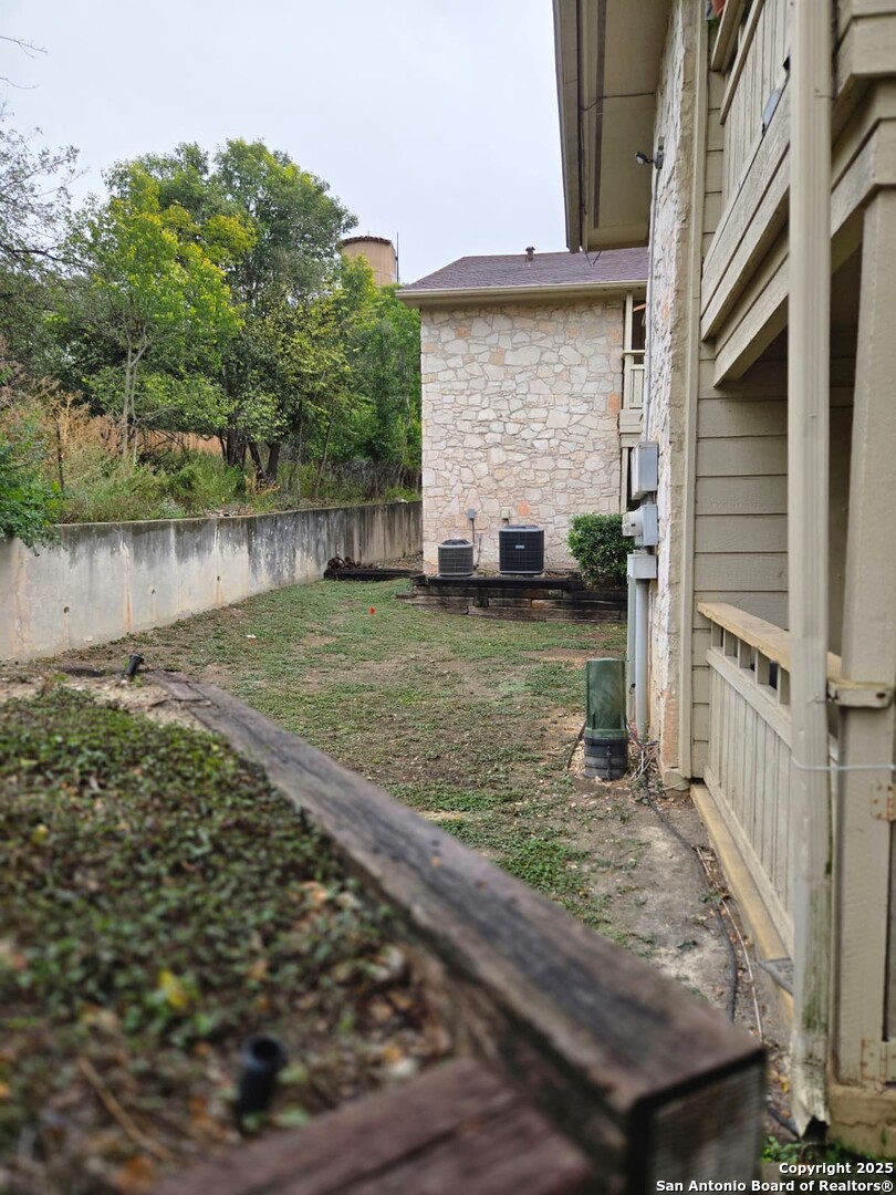7738 Chambers Road, Unit 1101 San Antonio, TX 78229 - Photo 6 of 35 a view of a backyard with large trees