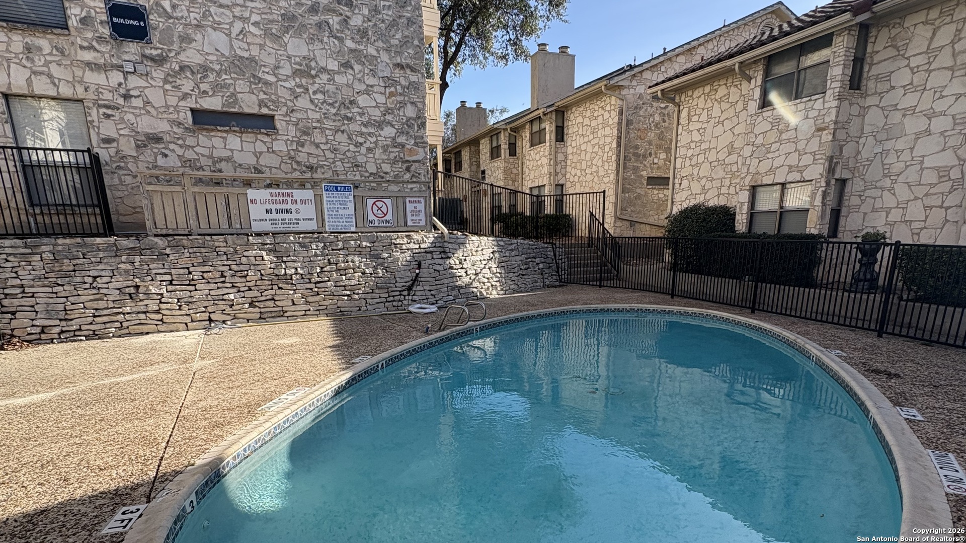 7738 Chambers Road, Unit 1101 San Antonio, TX 78229 - Photo 10 of 35 a view of a swimming pool with a patio