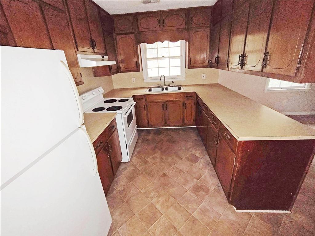 497 Highway 212 Covington, GA 30016 - Photo 4 of 14 a kitchen with a sink a window and cabinets
