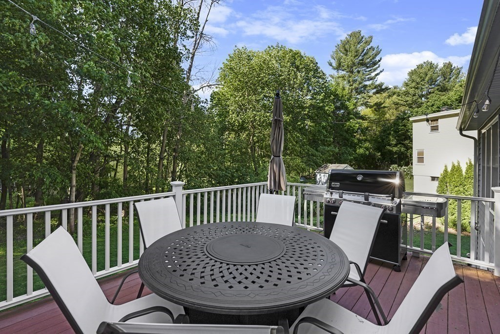 6 Alderbrook Road Andover, MA 01810 - Photo 25 of 29 a view of a deck with a table and chairs