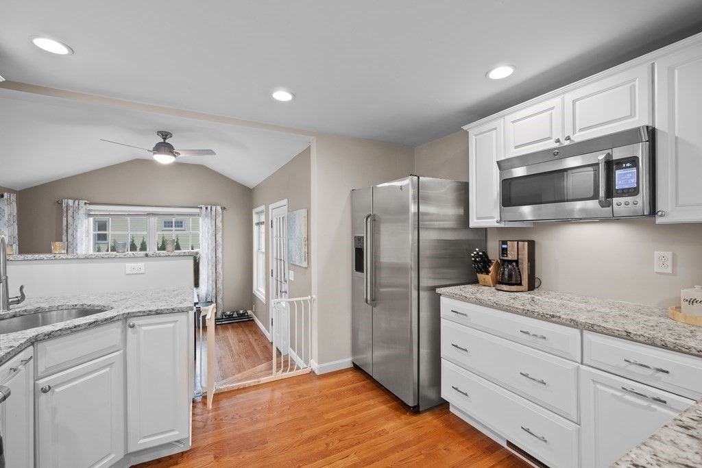 6 Alderbrook Road Andover, MA 01810 - Photo 7 of 29 a kitchen with granite countertop a refrigerator stove and microwave