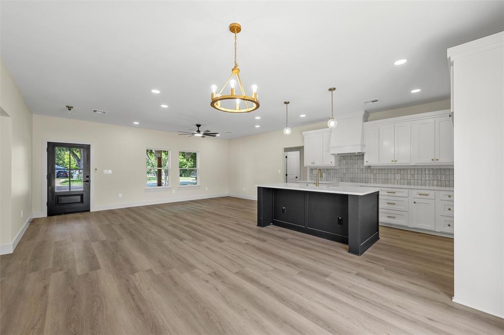 3320 North 27th Street Waco, TX 76708 - Photo 7 of 38 a view of an empty room and kitchen view with wooden floor