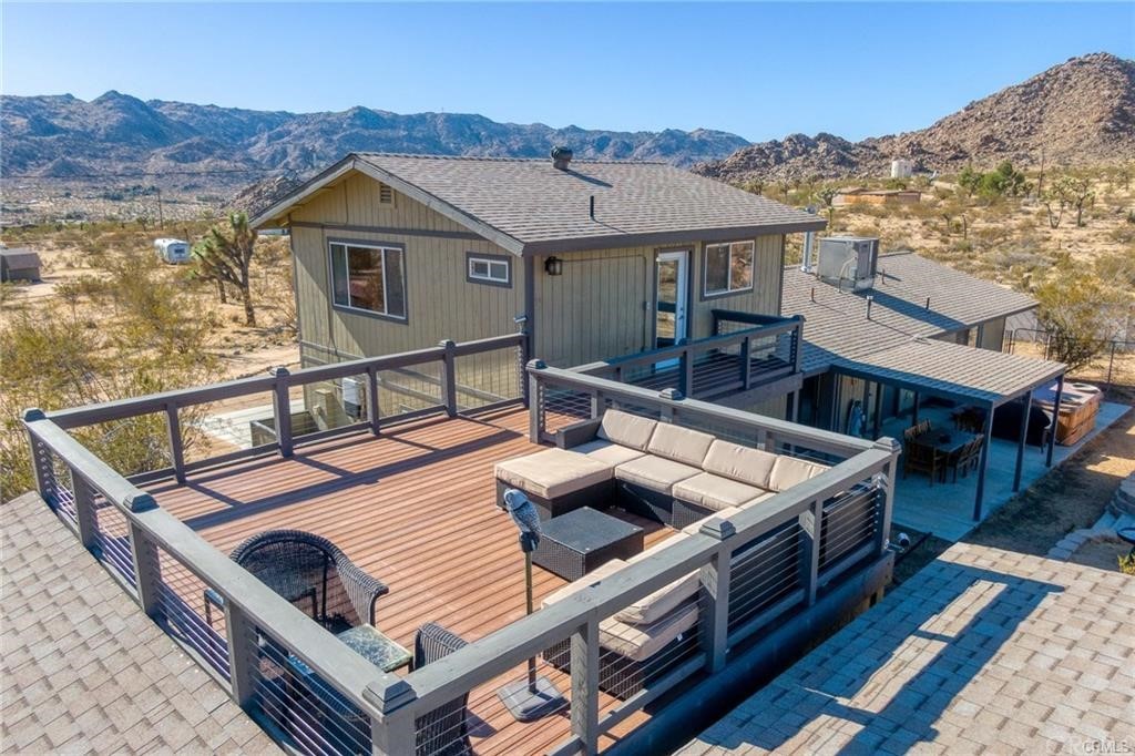 63442 Rocking Chair Road Joshua Tree, CA 92252 - Photo 1 of 1 a view of a roof deck with couches and wooden floor