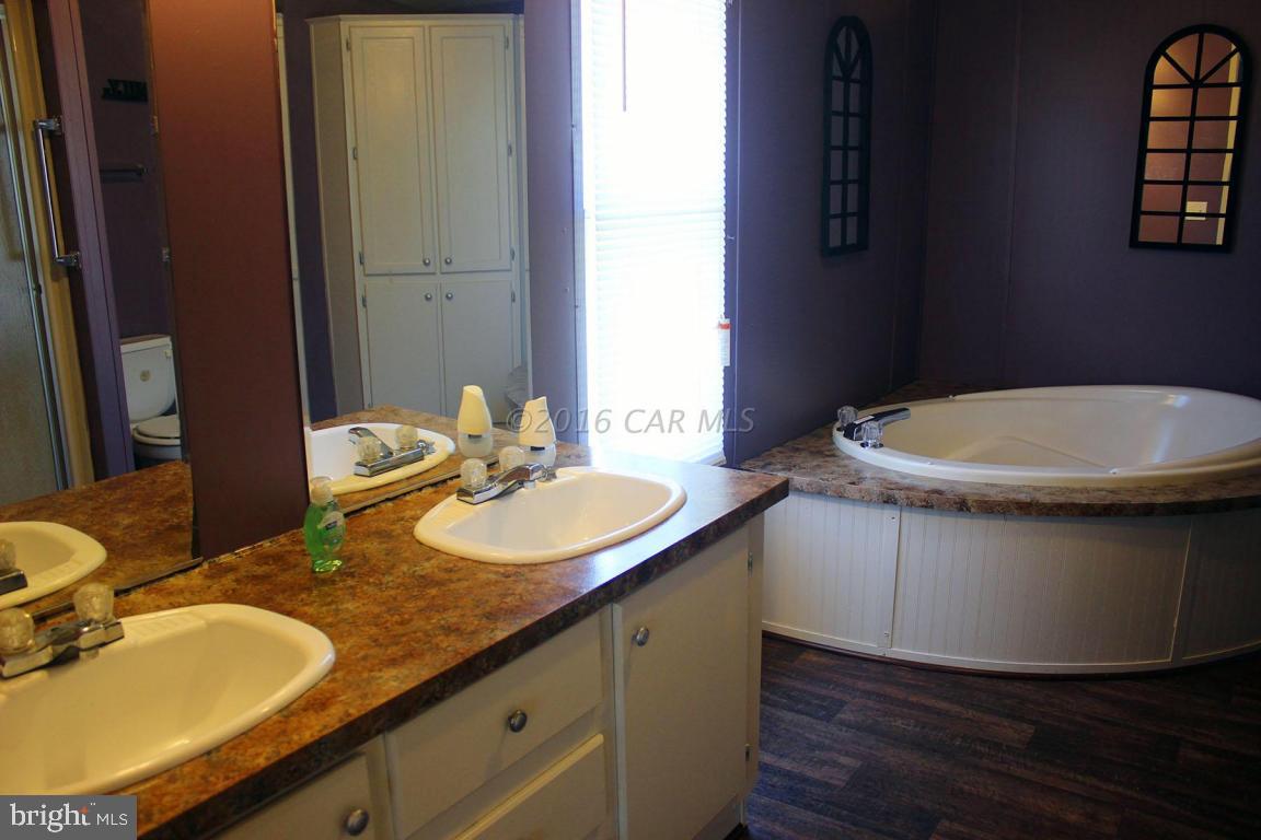 10841 Oriole Back Road Princess Anne, MD 21853 - Photo 6 of 12 a bathroom with a granite countertop sink and a mirror