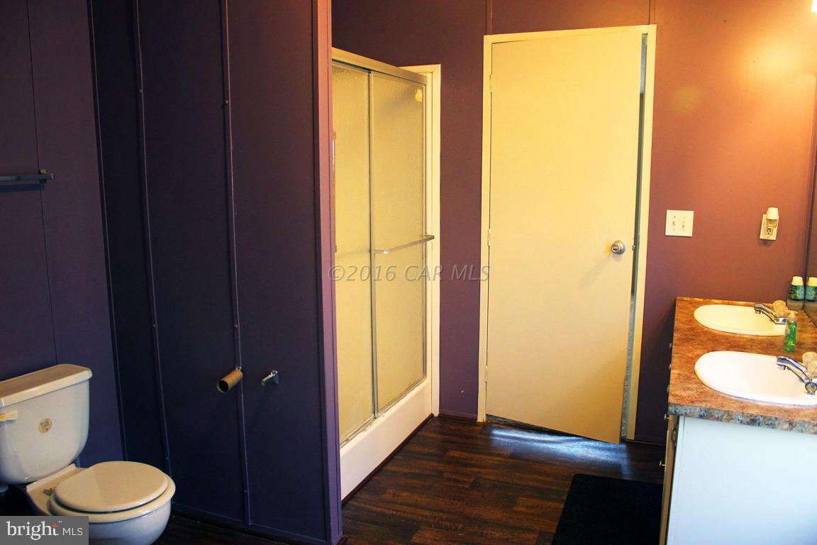 10841 Oriole Back Road Princess Anne, MD 21853 - Photo 7 of 12 a bathroom with a granite countertop toilet and a sink