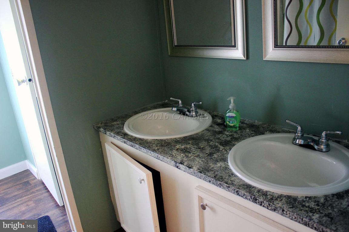 10841 Oriole Back Road Princess Anne, MD 21853 - Photo 10 of 12 a bathroom with a sink and a mirror