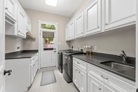a kitchen with granite countertop white cabinets and white appliances