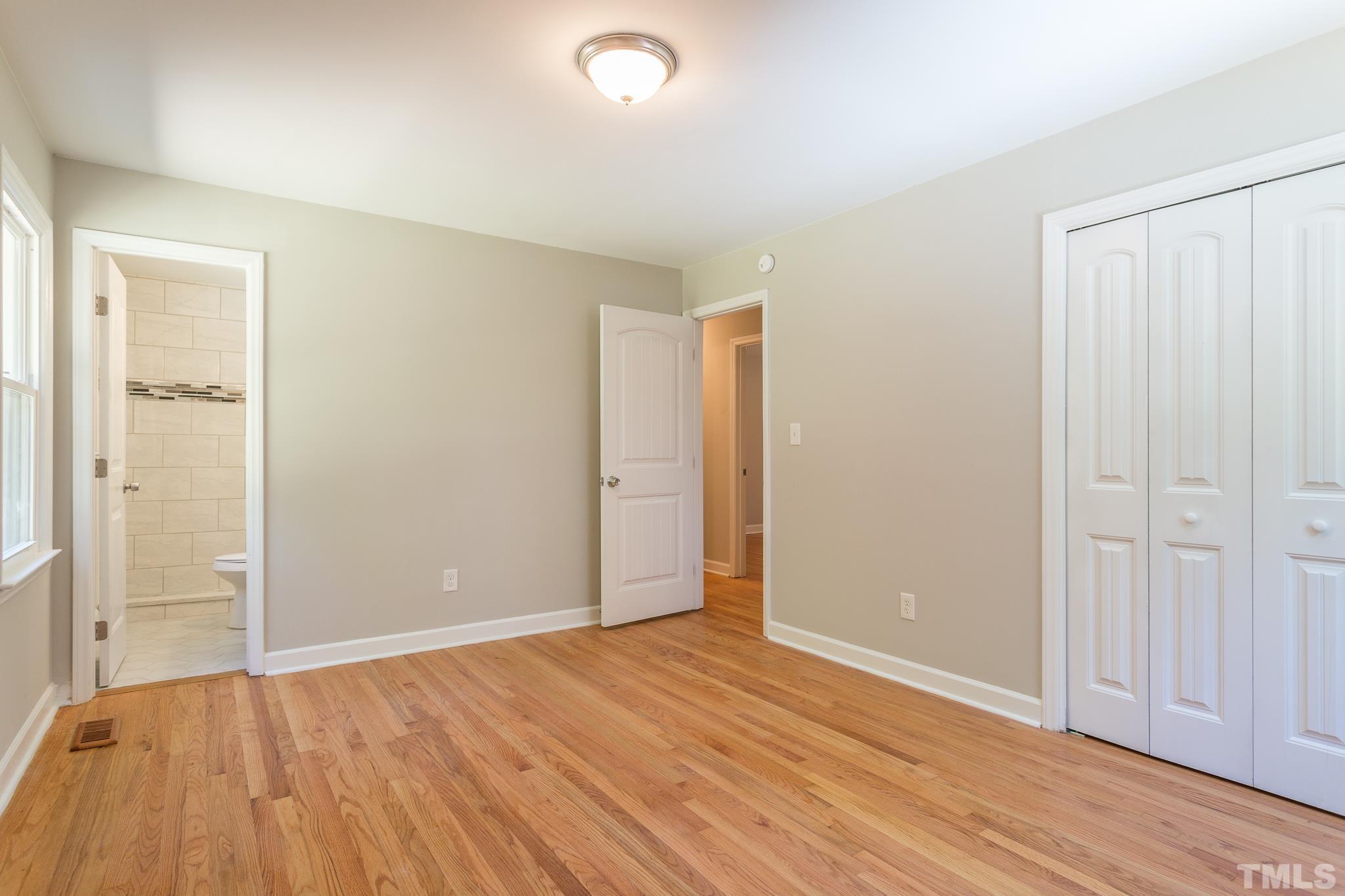 4809 Pearl Road Raleigh, NC 27610 - Photo 14 of 34 an empty room with wooden floor and closet