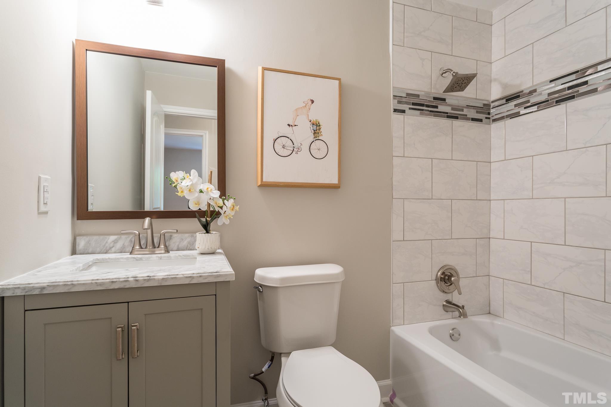 4809 Pearl Road Raleigh, NC 27610 - Photo 22 of 34 a bathroom with a sink a toilet and shower