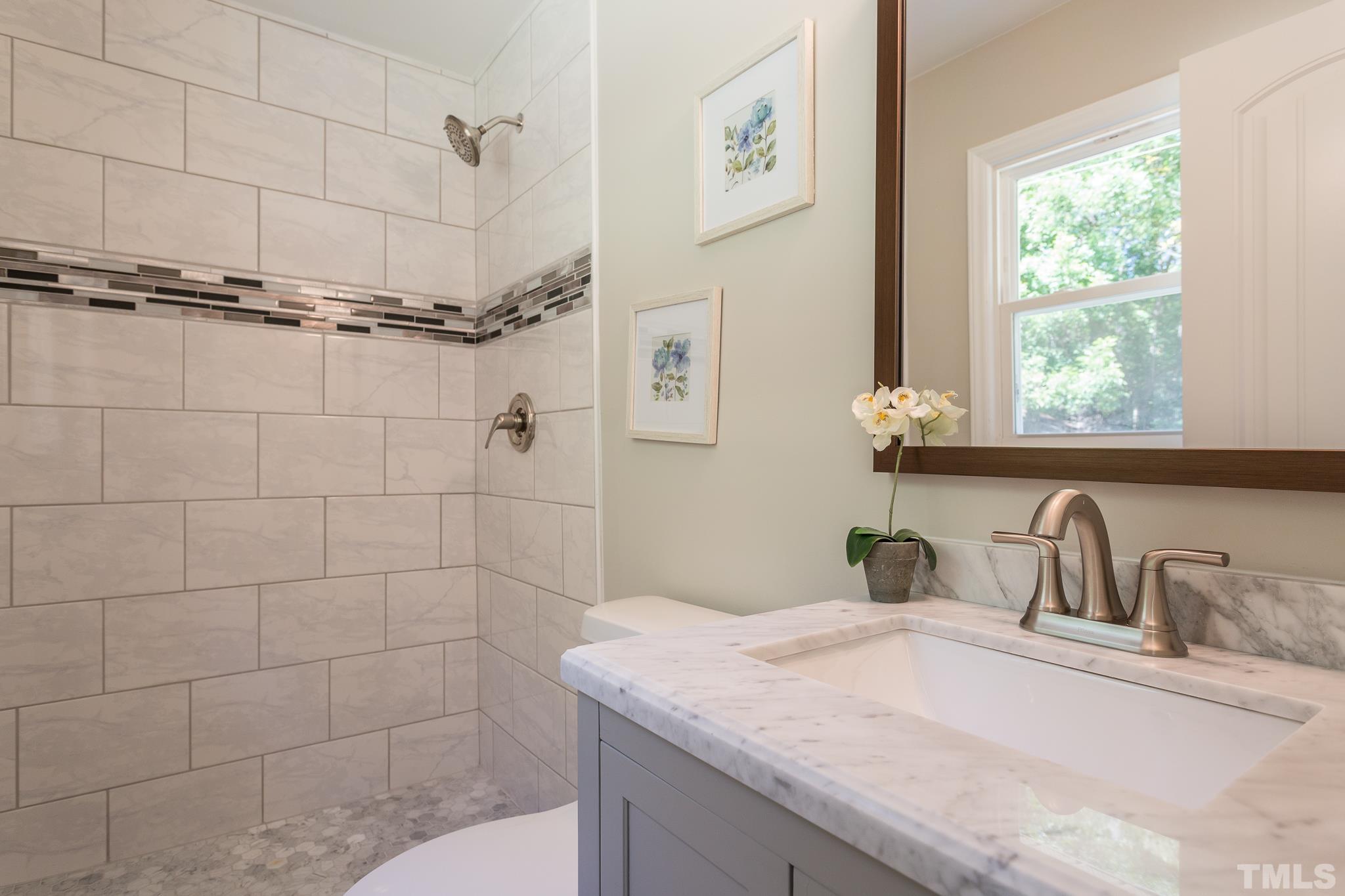 4809 Pearl Road Raleigh, NC 27610 - Photo 23 of 34 a bathroom with a granite countertop sink a toilet and shower