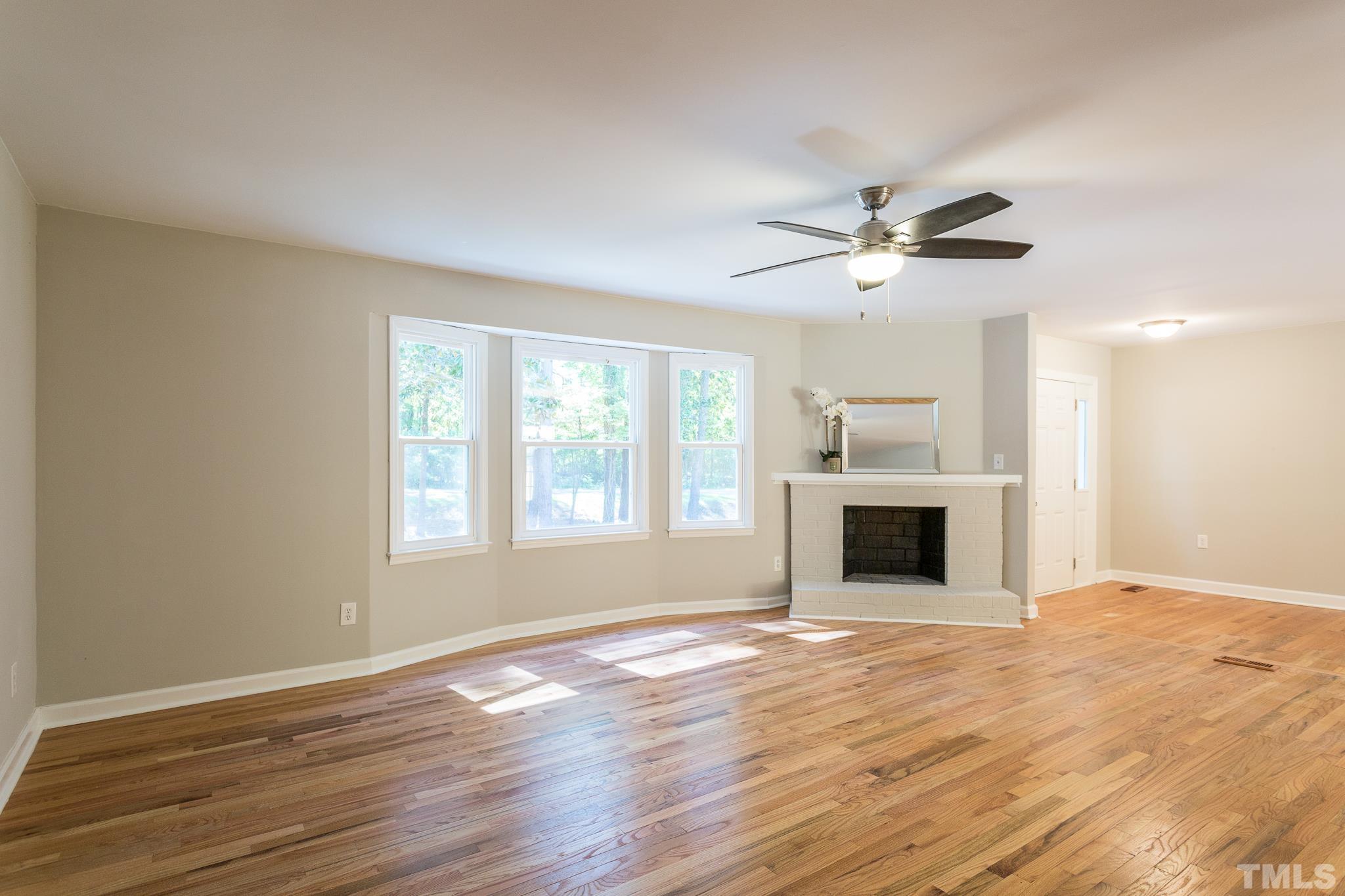 4809 Pearl Road Raleigh, NC 27610 - Photo 29 of 34 a view of an empty room with a kitchen and a window