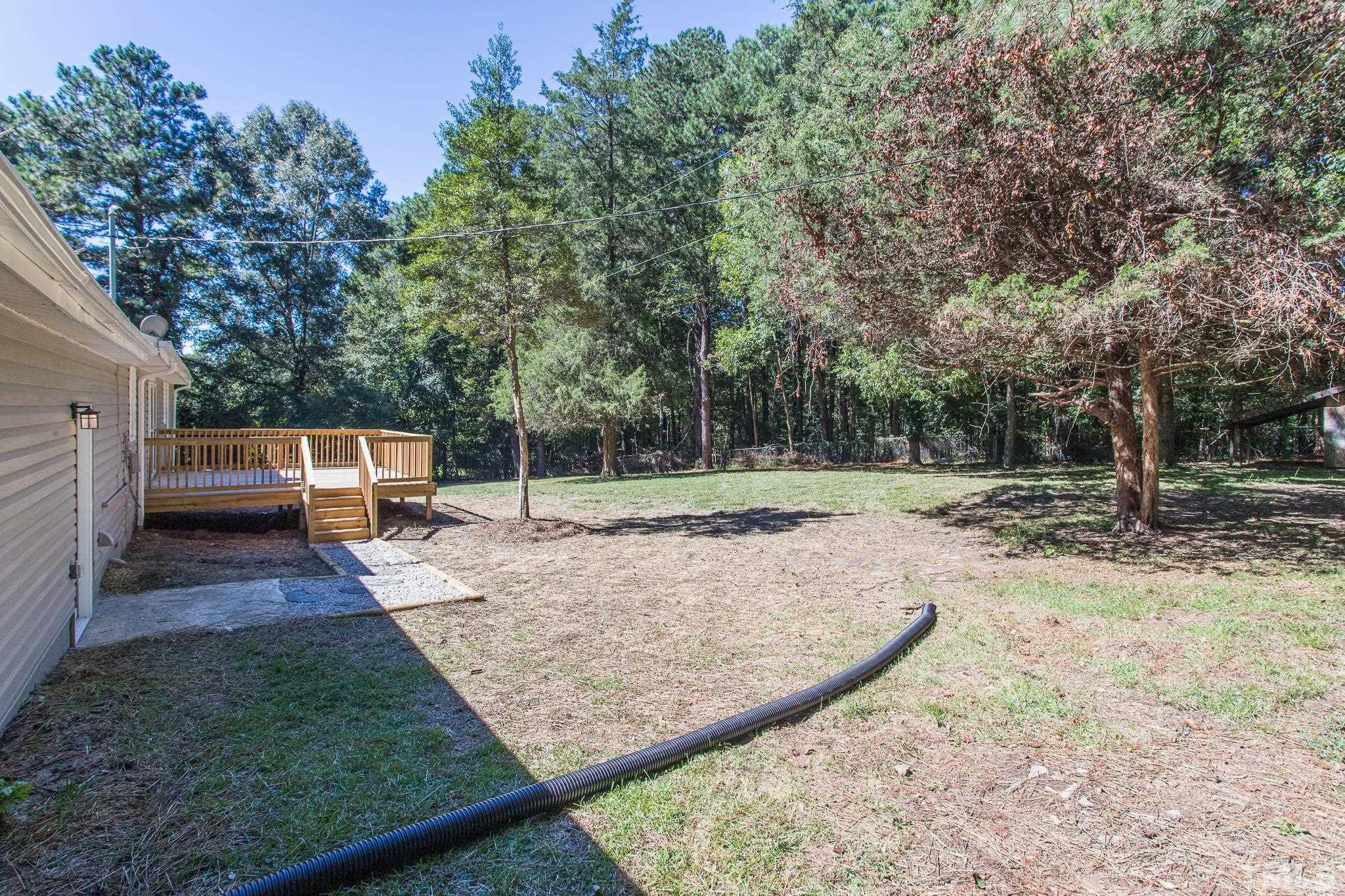 4809 Pearl Road Raleigh, NC 27610 - Photo 33 of 34 a view of a backyard with trees