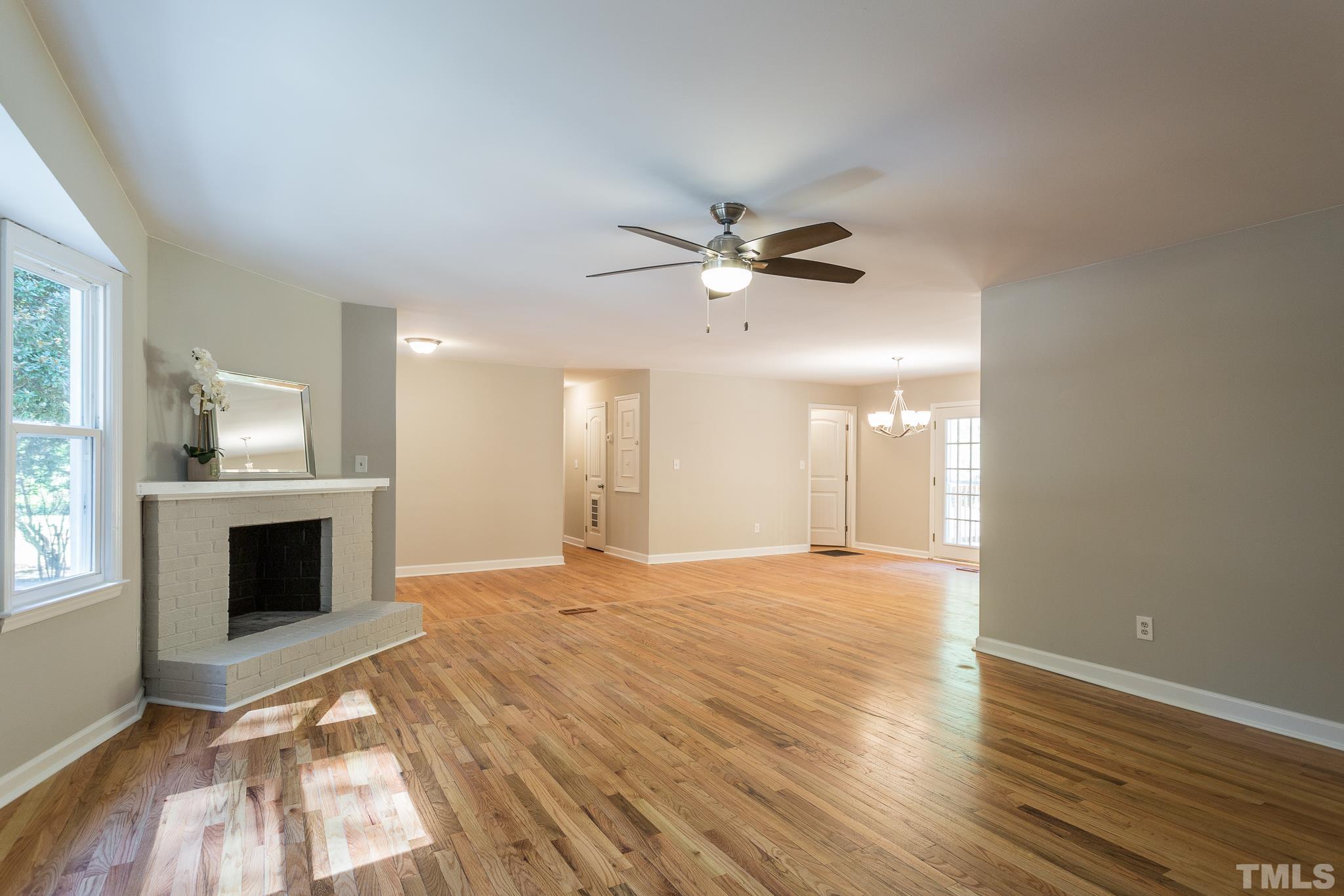 4809 Pearl Road Raleigh, NC 27610 - Photo 8 of 34 a view of an empty room with a fireplace and a window