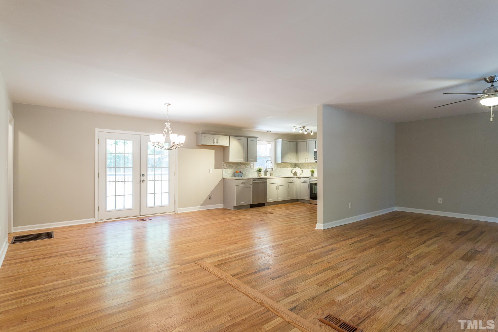 4809 Pearl Road Raleigh, NC 27610 - Photo 9 of 34 a view of a living room a kitchen with wooden floor
