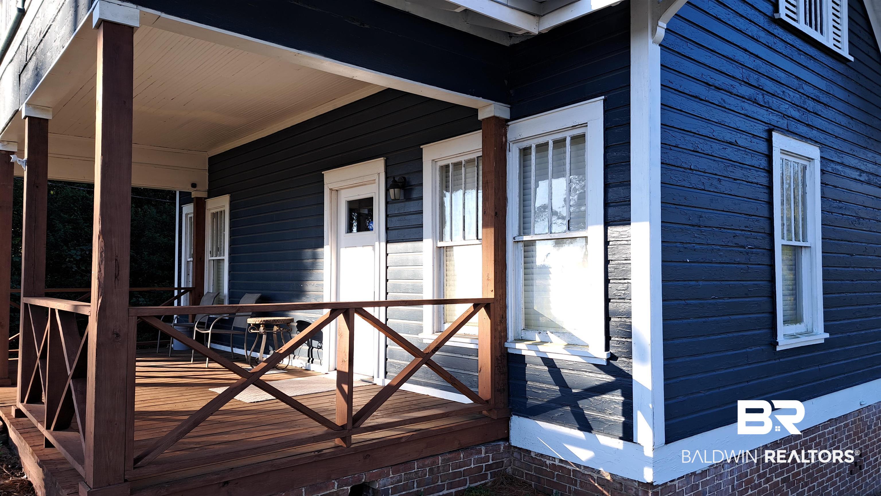 110 South Main Street Evergreen, AL 36401 - Photo 27 of 27 Deep blue horizontal siding exterior with white trim