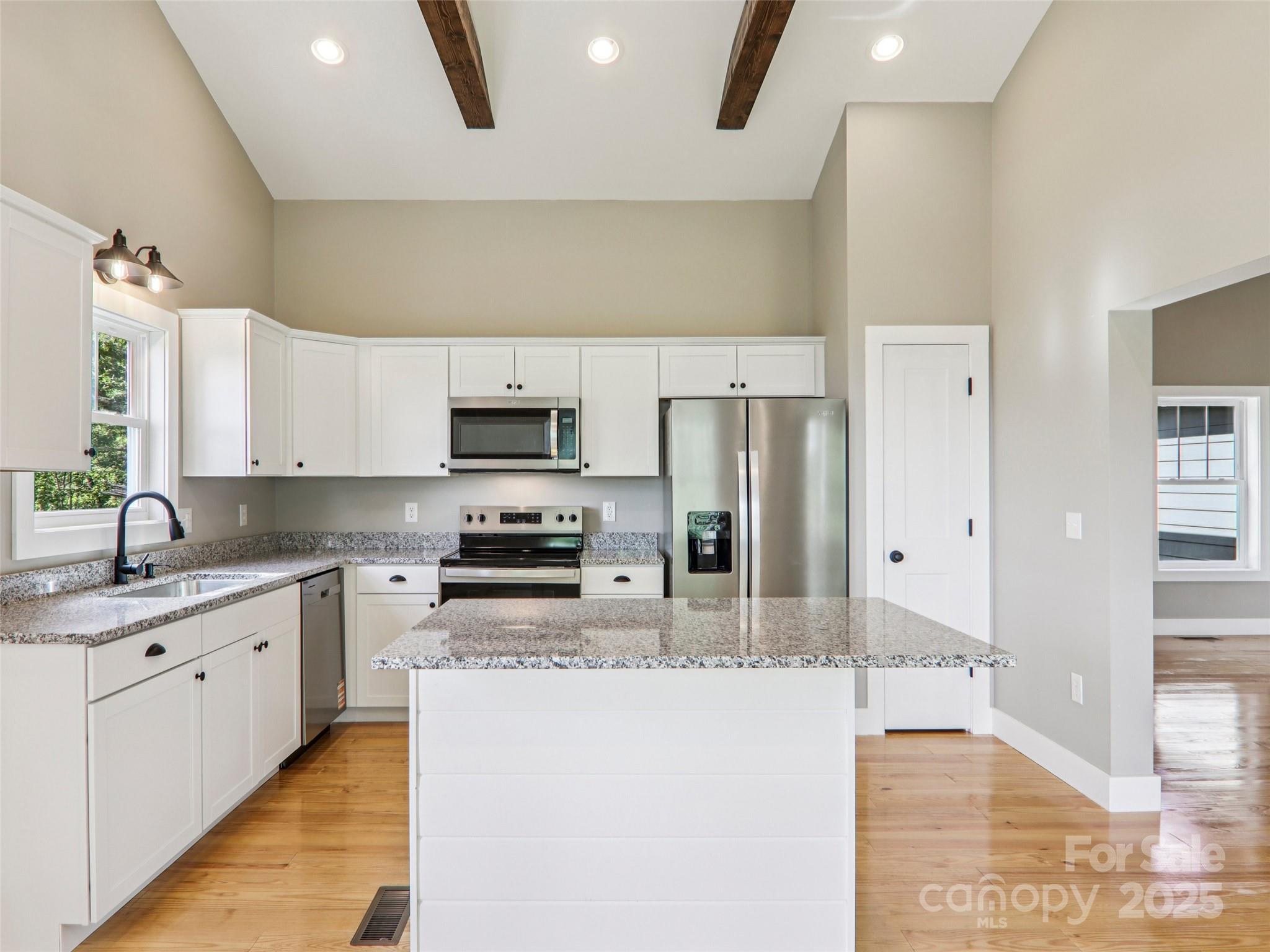 366 Ben Nevis Road Brevard, NC 28712 - Photo 12 of 48 a large kitchen with stainless steel appliances granite countertop a stove a sink and a refrigerator