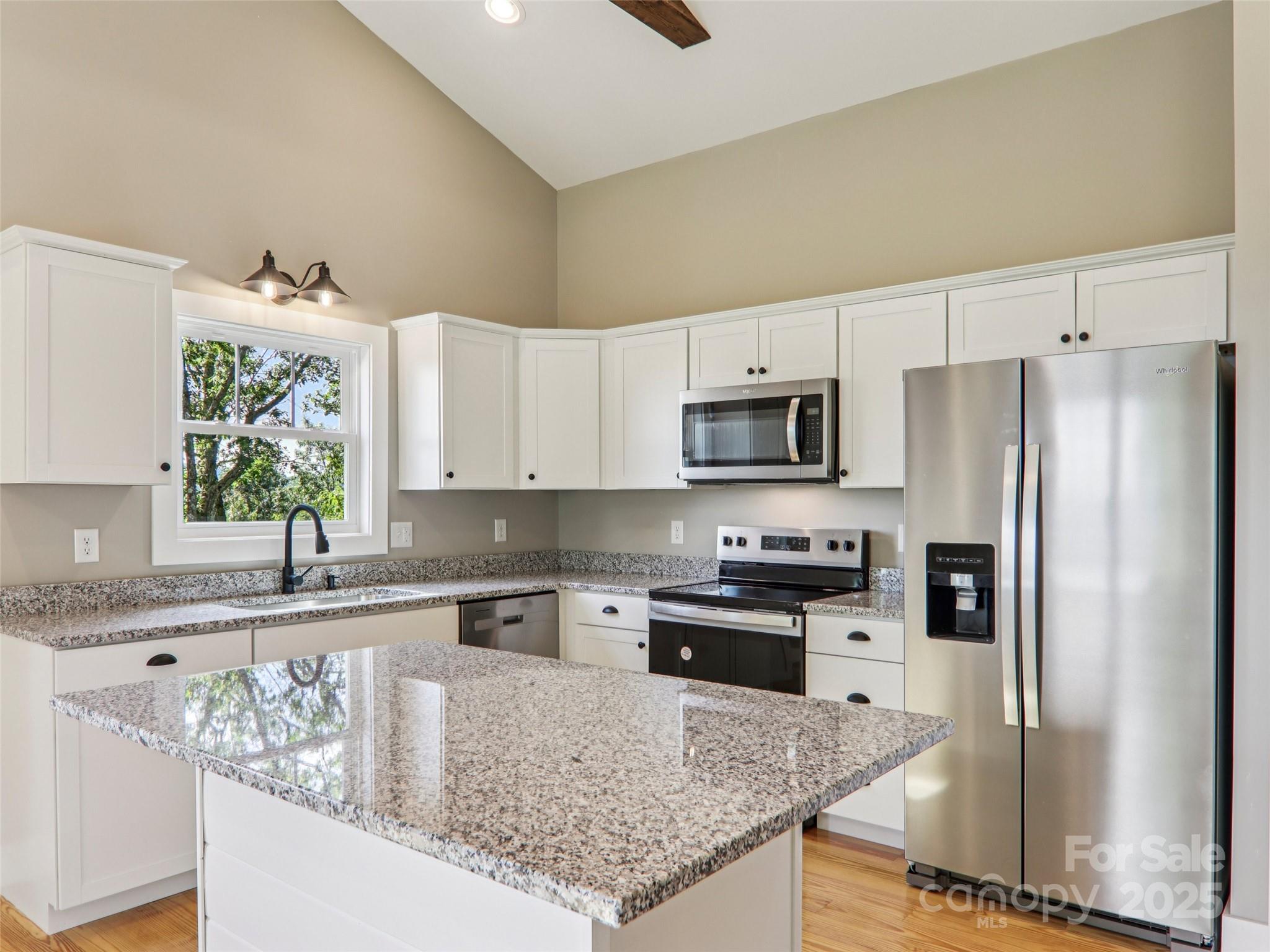 366 Ben Nevis Road Brevard, NC 28712 - Photo 13 of 48 a kitchen with stainless steel appliances granite countertop a refrigerator a stove top oven a sink and dishwasher