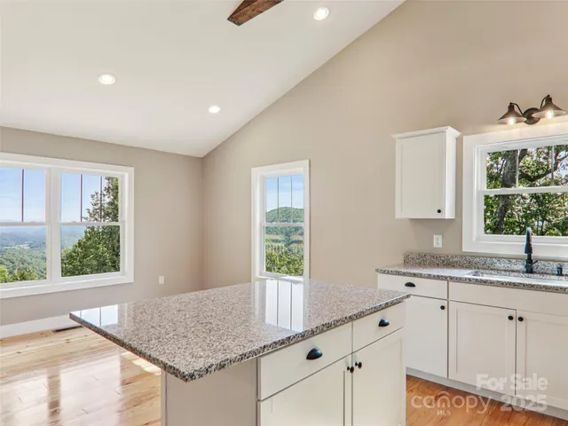 a kitchen with stainless steel appliances granite countertop a stove microwave and cabinets