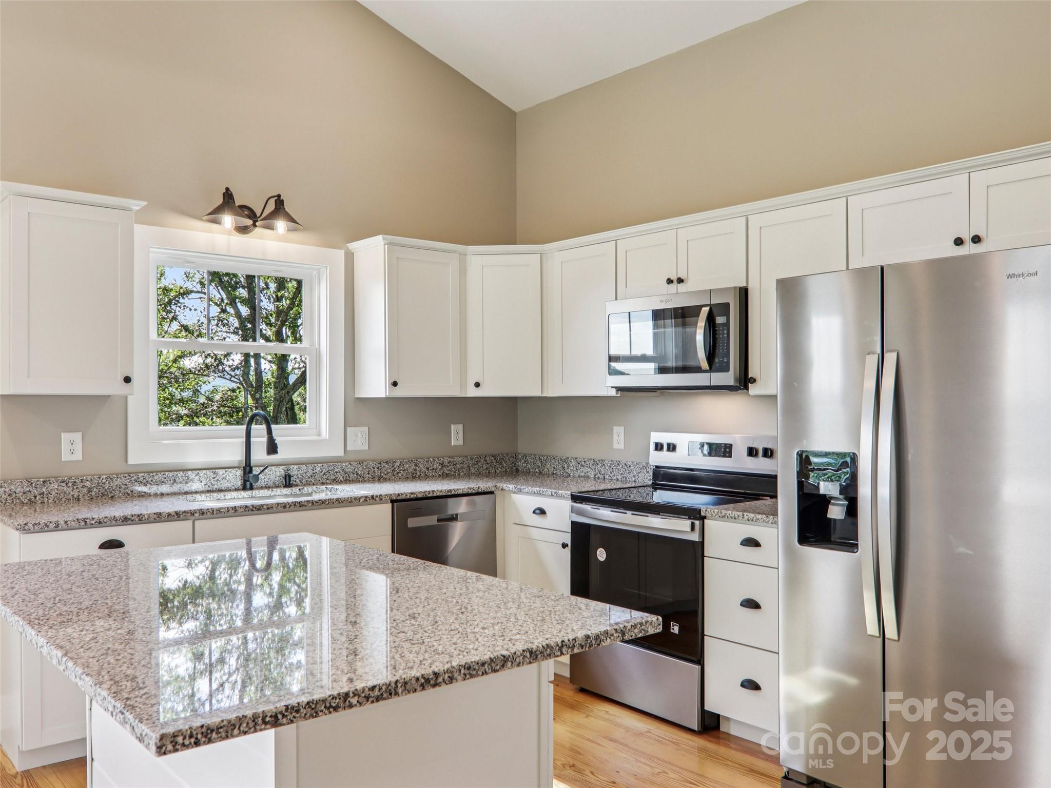 366 Ben Nevis Road Brevard, NC 28712 - Photo 18 of 48 a kitchen with granite countertop a sink stove and refrigerator