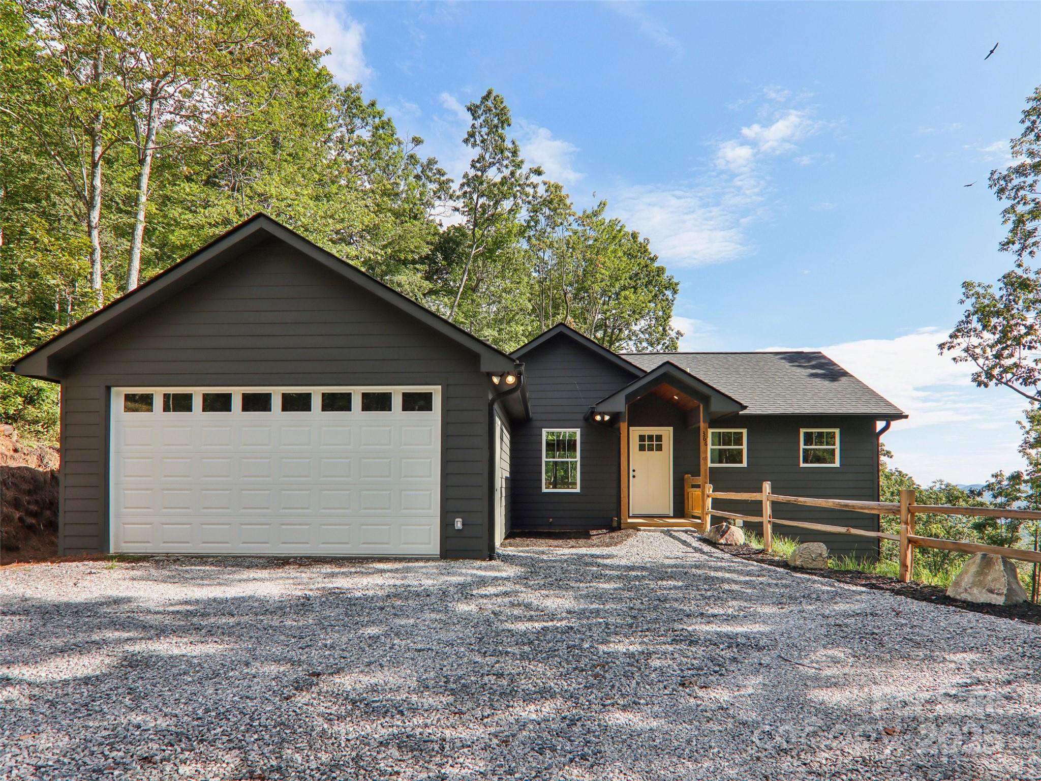 366 Ben Nevis Road Brevard, NC 28712 - Photo 2 of 48 a front view of a house with a garden and trees