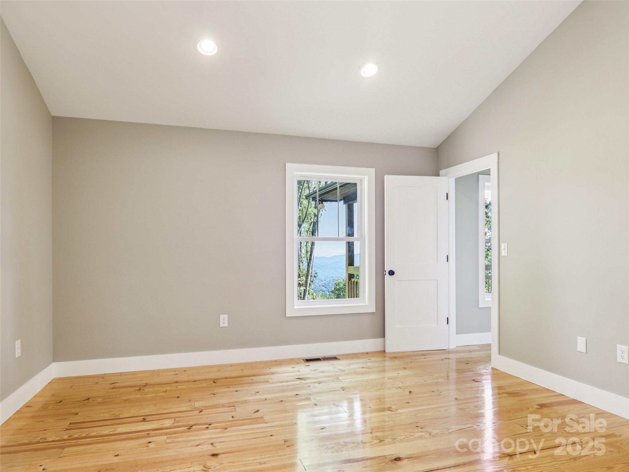 366 Ben Nevis Road Brevard, NC 28712 - Photo 25 of 48 a view of an empty room with wooden floor and window