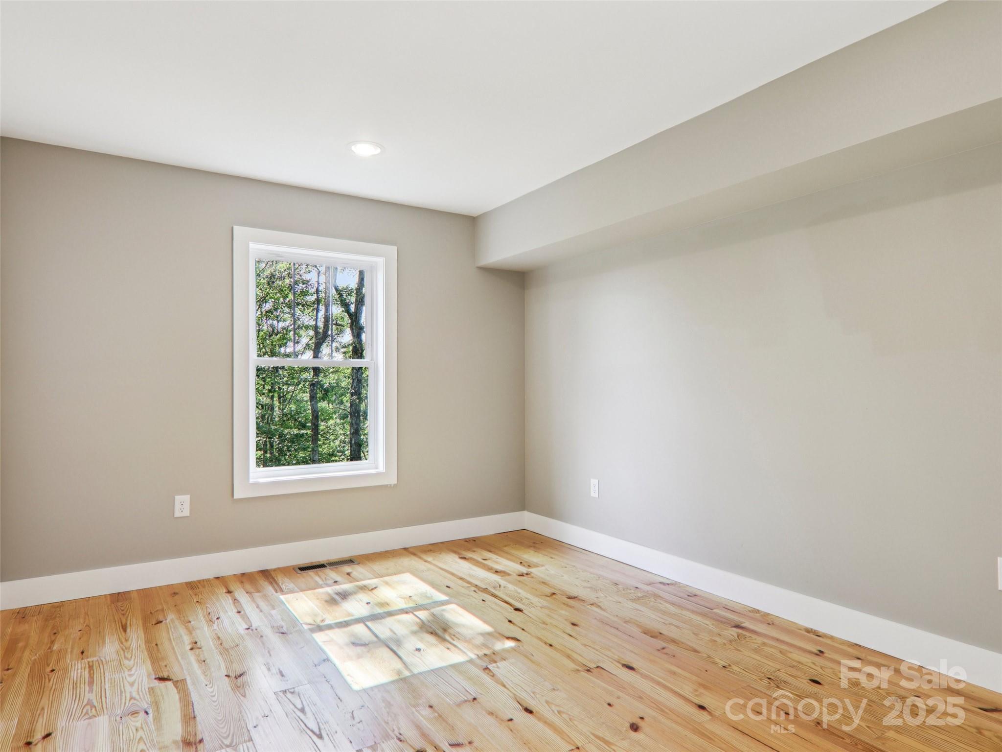 366 Ben Nevis Road Brevard, NC 28712 - Photo 28 of 48 an empty room with wooden floor and window
